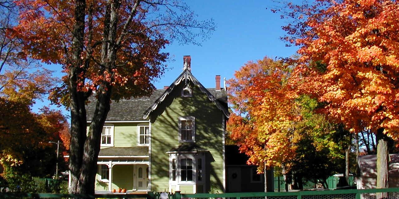 Autumn colored trees framing a beautiful home